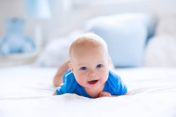 istock Baby boy in white sunny bedroom 542825966