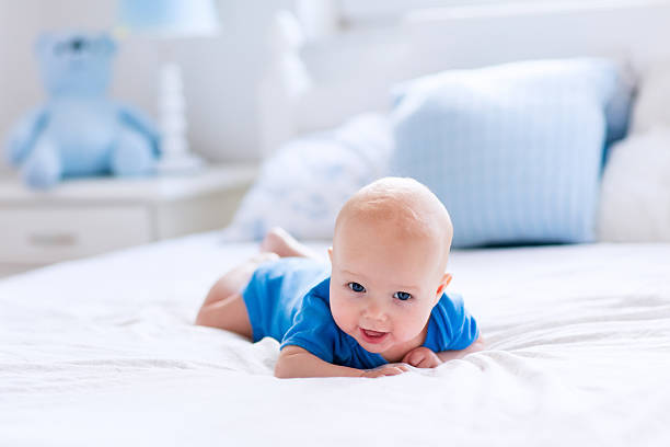 istock Adorable baby boy in white sunny bedroom 542826258
