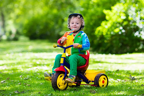 istock Cute little boy on colorful tricycle 542826774