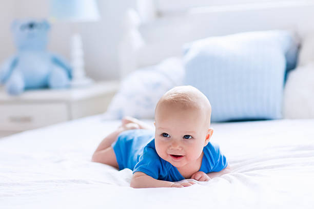 istock Newborn baby boy in white sunny bedroom 542826864