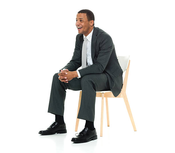 istock Cheerful businessman sitting on chair 542827428