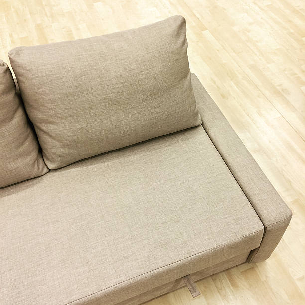 istock Elegant sofa-bed on wooden floor 542828126