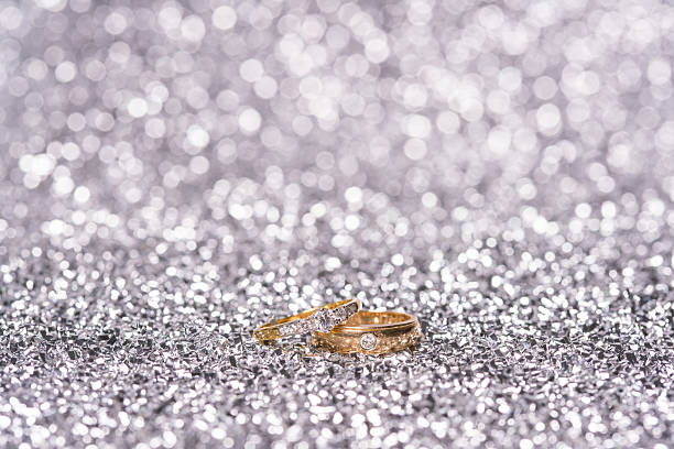 istock two gold ring with diamond. Jewelry with bokeh background 542830542
