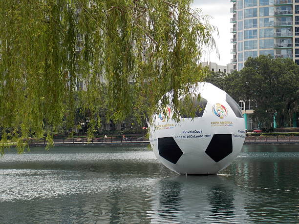 Orlando, FL, USA - May 21, 2016: On Lake Eola, a huge inflated soccer ball advertising the Copa America competition floats.