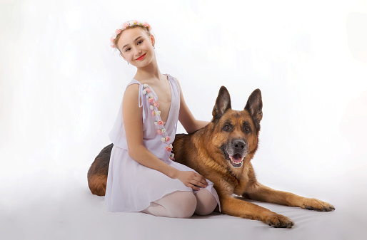 Young woman smiling and posing with dog outside