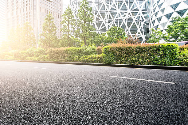 istock empty road near modern office building with abstract wall 542831752