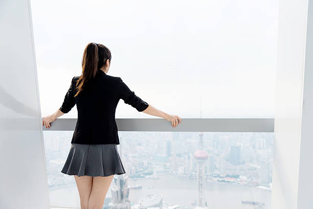 istock Businesswoman looking through the window 542831928
