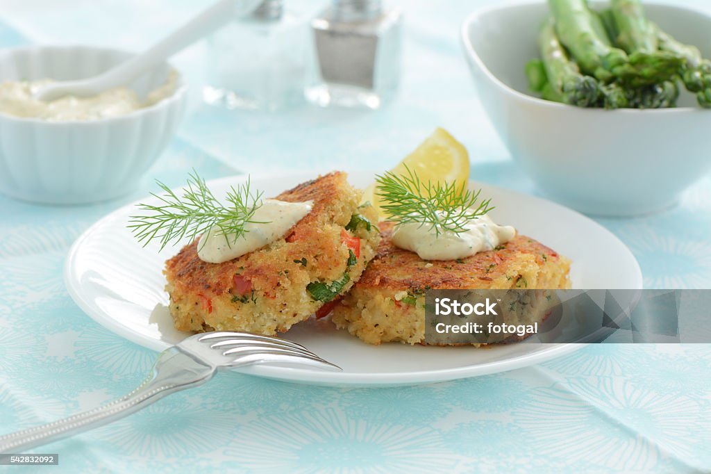 Crab Cakes Fresh home made crab cakes with creamy lemon dill sauce Fish Cakes Stock Photo