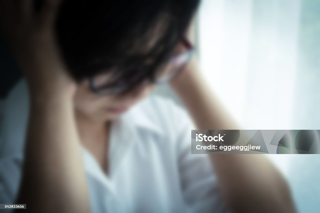 Blurred of business Woman be ill Blurred of business Woman be ill when she work hard. Blurred of asian woman be ill and having headache. Blurred of eyeglasses girl be ill and having headache. stressed, depressed concept. Adult Stock Photo