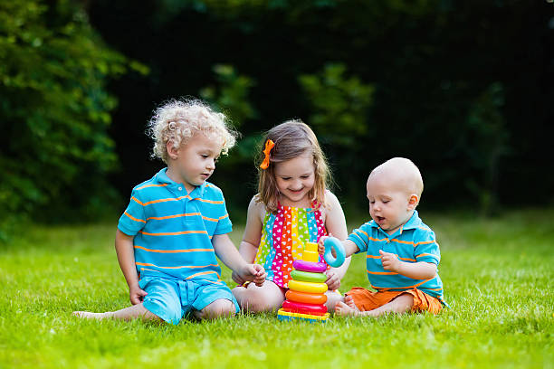 istock Sibling children playing with toy pyramid 542834906