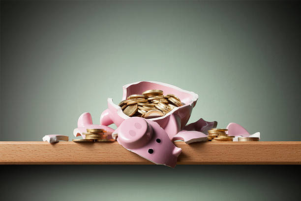 istock Savings. Broken piggy bank with coins. 542835130