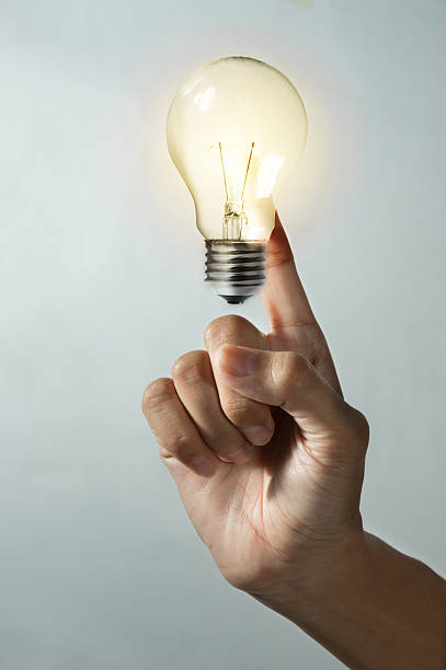 istock Woman finger with light bulb. 542835138