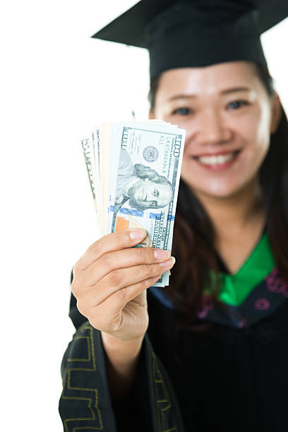 istock Female graduate with money 542835594