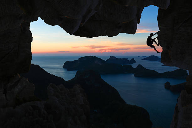 istock Man climbing cave on the mountain. 542836594