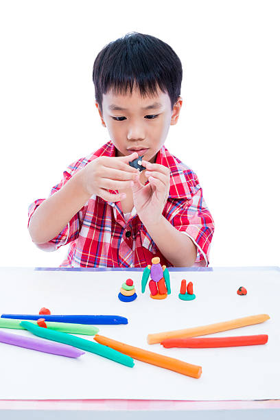 istock Child moulding whale modeling clay, on white background. Strengt 542837080
