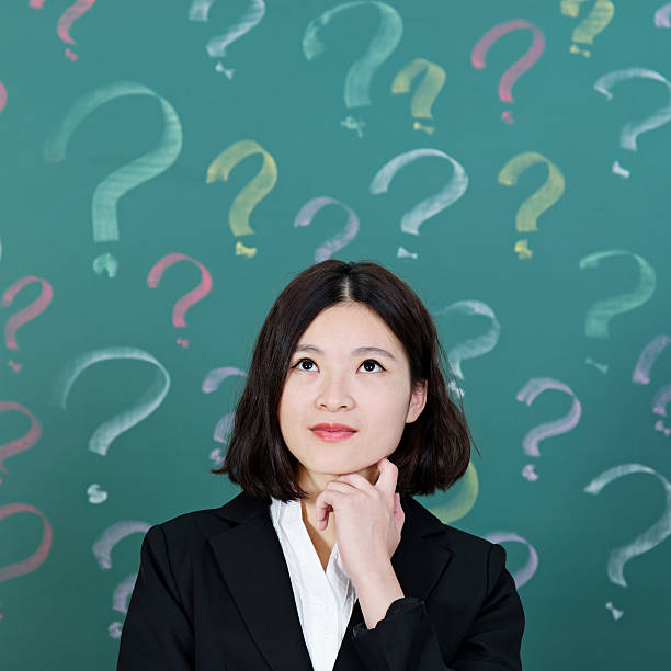 istock Businesswoman with question marks 542838492