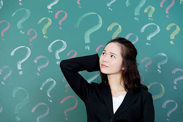 istock Businesswoman with question marks 542927912