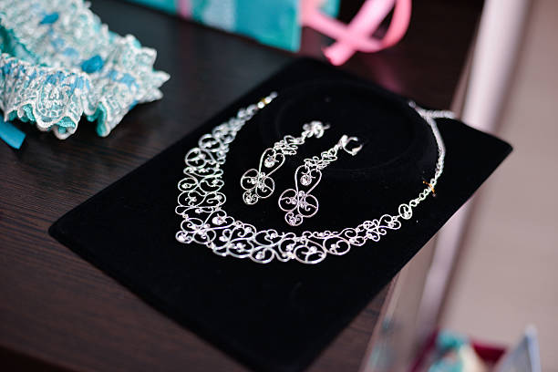istock diamond and pearl necklace on black background with earrings 542927950