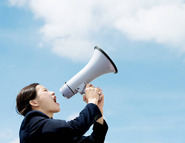 istock Businesswoman shouting through megaphone 542930940