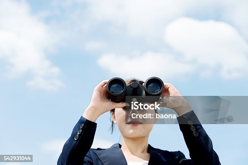 istock Businesswoman with binoculars 542931044