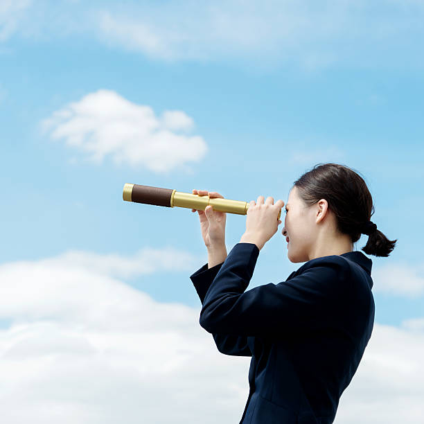 istock Businesswoman with telescope 542931124