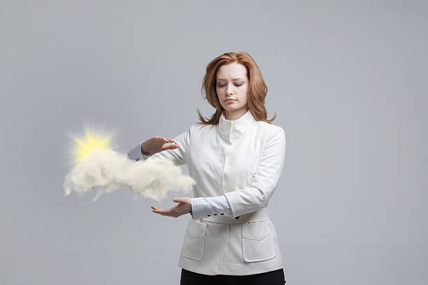 istock Young woman and sun shining out from behind the clouds 542931318