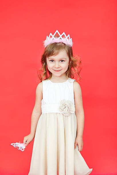 istock Singing Fairy Girl in white over red background 542934298