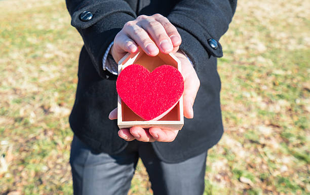 istock Asian man holding heart 542934368