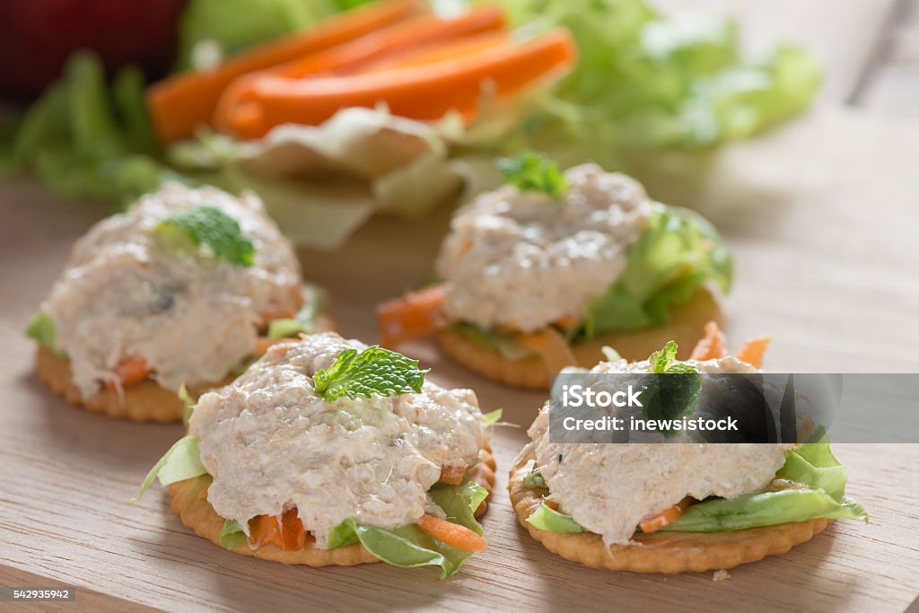 Delicious crackers with tuna salad topping. Cracker - Snack Stock Photo