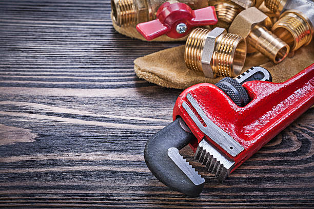 istock Composition of protective gloves brass plumbing equipment on woo 542935950