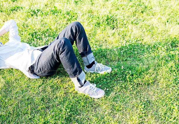 istock Asian man lying lying at green field 542937042