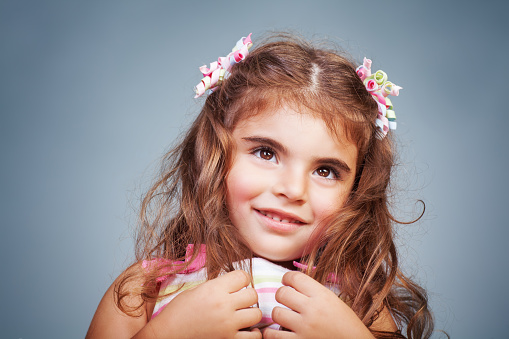 Cute smiling girl. She is against white background.