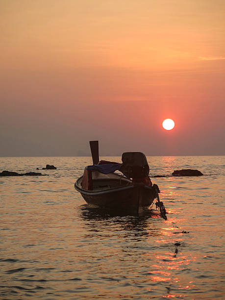 istock Tropical Sunset Wooden Longtail Boat 542939890