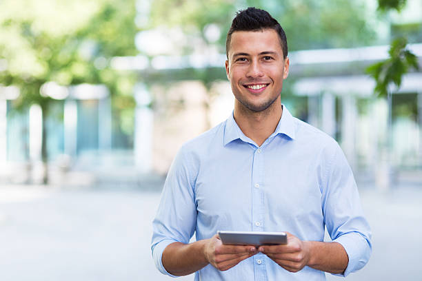 istock Young man with digital tablet outdoors 542940180