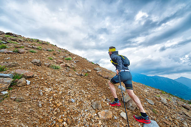 skyrunner athlete while training in the mountains with sticks - running jogging mountain footpath imagens e fotografias de stock