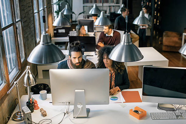 istock Young creative business people working late in the office 542941652