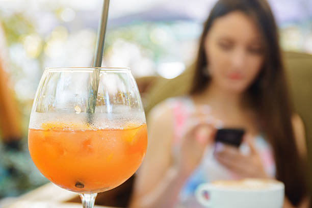 istock young beautiful woman sitting in a cafe drinking cocktail 542942430