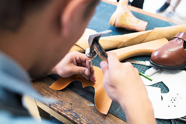 istock Over the shoulder view of a shoe maker 542943780