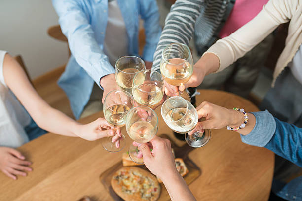 Overhead close up of five glasses of wine clinking in a toast like manner. Kyoto, Japan. May 2016