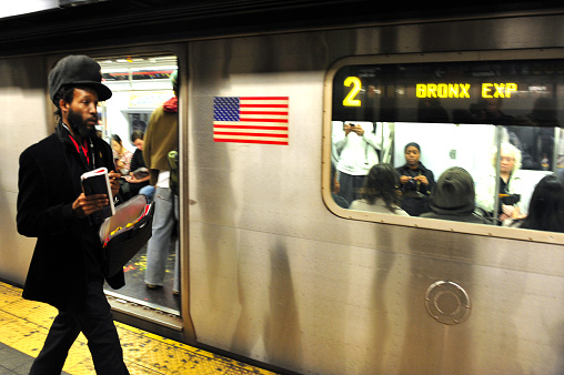 New York, New York, United States - October 8, 2009: American African on a platform of the New York subway in Manhattan New York, USA. It's the seventh busiest rapid transit rail system in the world