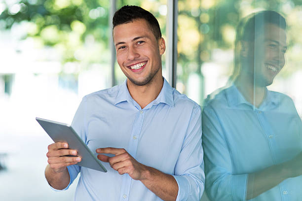 istock Young man with digital tablet outdoors 542944694