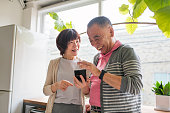Senior couple looking at a smartphone laughing