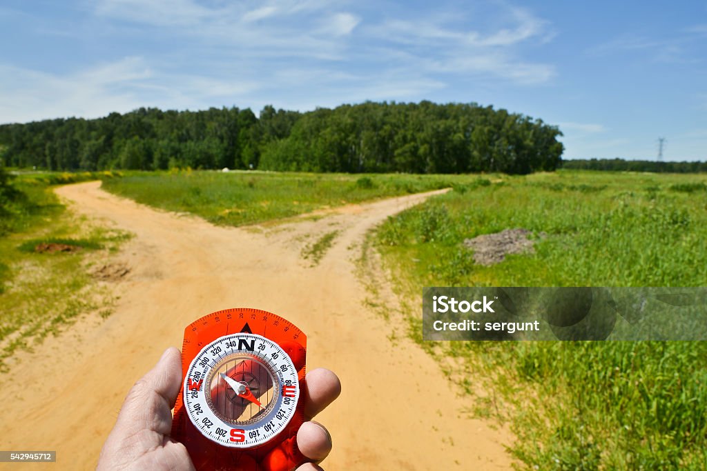 With the compass on a walk. With the compass on a walk. Man's hand holds a magnetic compass. Adult Stock Photo