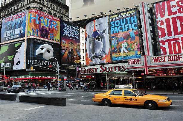 New York, New York, United States - October 8, 2009: Yellow taxi cabs drive in Times Square, featured with Broadway Theaters and animated LED signs, is a symbol of New York City and the United States in Manhattan, New York, USA City. USA.