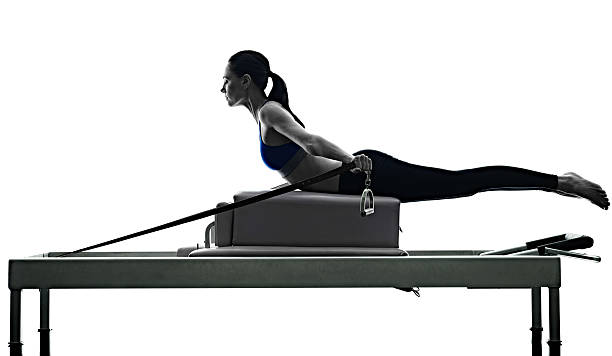woman pilates reformer exercises fitness isolated stock photo