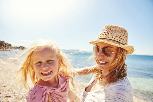 istock Happy mother and daughter at the beach 542947266