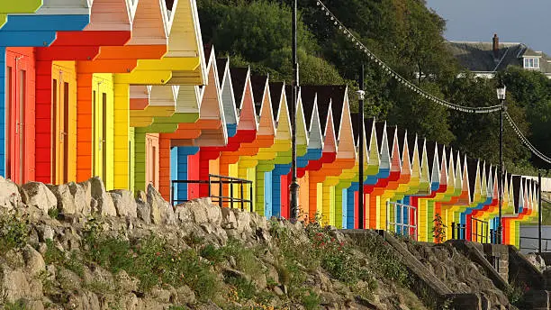 Very colourful beach huts along the promenade on the north bay of Scarborough, a traditional seaside town in Yorkshire, England.