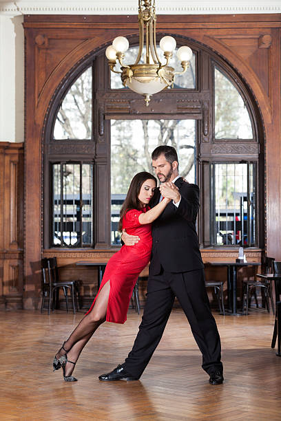 full length of dancer leaning on partner while performing tango - couple restaurant day south america imagens e fotografias de stock