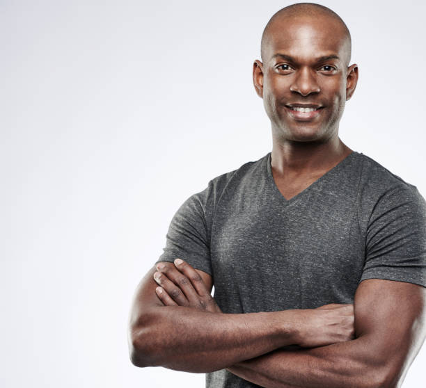istock Cute muscular grinning man with folded arms 542948222