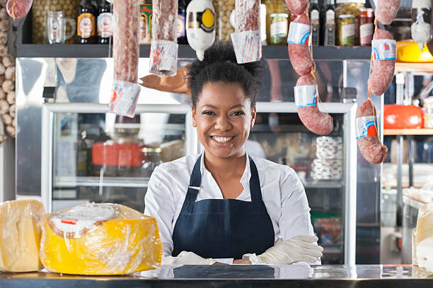 portrait of happy saleswoman in cheese shop - cheese counter supermarket bildbanksfoton och bilder